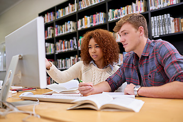 Image showing Two heads are better than one. Shot of two students working together at a computer in a university library.