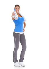 Image showing Woman, training and water bottle in studio for health, wellness and fitness on a white background. Portrait of happy person or sports model with towel and liquid offer for energy, workout or exercise