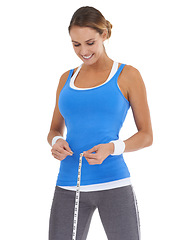 Image showing Woman, stomach and measure tape for fitness, weight loss and health results or training progress in studio. Model check body or abdomen for exercise goals and diet or workout on a white background