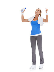 Image showing Woman, fitness success and celebration in studio with water bottle for exercise, workout success or body goals. Excited model with fist, power and yes or energy for training on a white background