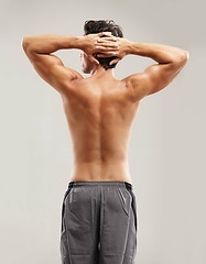 Image showing Back, topless or model for fitness results, wellness and health isolated on grey background in studio. Hands up, man or male person with progress in exercise, workout and training on a backdrop alone