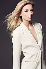 Image showing Woman, face and professional clothes for fashion, beauty and wellness with confident model on dark background. Corporate jacket, ambition and power in portrait with business style in a studio