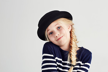 Image showing Fashion, smile and portrait of child in a studio with casual, cool and stylish outfit and hat. Happy, youth and young girl kid with positive, good and confident attitude for style by white background