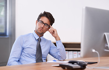 Image showing Businessman at desk, thinking or planning with research, ideas and doubt for problem solving. Corporate, confused and professional consultant in workplace for project vision, choice and solution