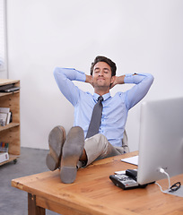 Image showing Nap, relax or happy man in office on break for mental health, pride or wellness at his desk or workplace. Calm, business or employee sleeping with smile or hand behind his head stretching or resting