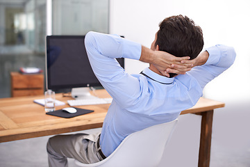 Image showing Back, relax or happy man in office on break for mental health, pride or wellness at his desk or workplace. Calm, business or employee sleeping with peace or hand behind his head stretching or resting