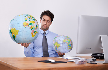 Image showing Travel, choice or confused businessman with planet, earth or worldwide destination for trip in office. Computer, holiday or professional agent with map of globe for geography or international journey