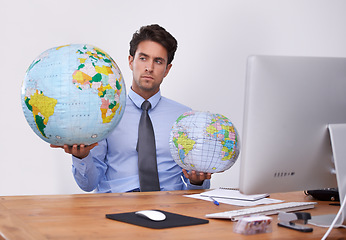 Image showing Travel, choice or businessman with globe, earth or worldwide destination for trip in office. Agent, computer or professional person with map of planet for geography, vacation or international journey