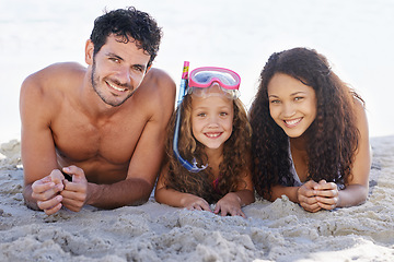 Image showing Happy family, portrait and relax on beach for bonding, vacation or outdoor holiday weekend together. Face of dad, mom and kid smile lying on sand by the ocean coast for fun summer break in nature