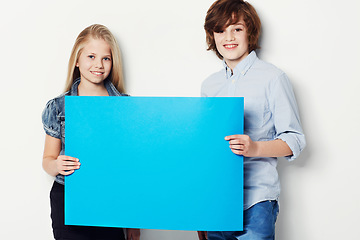 Image showing Happy teens, portrait and billboard for advertising, marketing or mockup space on a white studio background. Young man and woman or gen z smile with blue poster or empty sign for presentation or vote