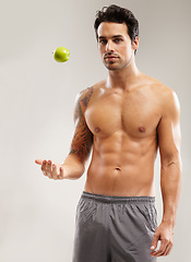 Image showing Portrait, topless or man with apple, fitness or healthy diet for six pack abs in studio on gray background. Weight loss, throw or male person with a natural fruit for nutrition, vitamin c or wellness