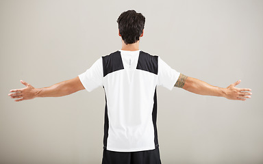 Image showing Back, athlete or model for fitness results, wellness and health isolated on grey background in studio. Arms out, man or male person with progress in exercise, workout and training on a backdrop alone