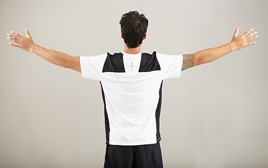 Image showing Back, athlete or man for fitness results, wellness and health isolated on grey background in studio. Arms out, model or male person with progress in exercise, workout and training on a backdrop alone