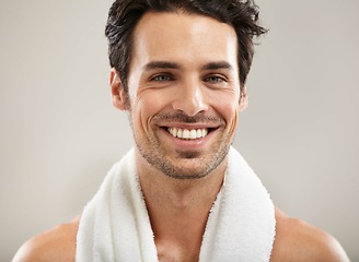 Image showing Towel, portrait or happy man in studio for fitness workout, sports exercise or healthy wellness. Smile, grey background or model athlete ready to start training with confidence, discipline or pride