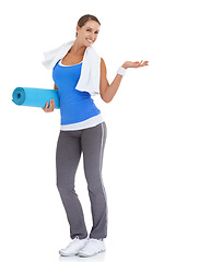 Image showing Yoga mat, hand and portrait of woman in studio with mockup space for exercise or workout. Happy, equipment and young female person with show gesture for fitness or sports isolated by white background