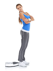 Image showing Young woman, portrait and scale for fitness, weight loss or diet on a white studio background. Female person with arms crossed standing in confidence for workout, exercise or training on mockup space