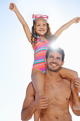 Image showing Happy father, girl and piggyback at beach for summer holiday, weekend or vacation together. Dad carrying child, kid or daughter on shoulders in the sun for fun day by the ocean or outdoor nature