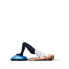 Image showing Woman, lying and workout on bosu ball for exercise, training or abs on a white studio background. Active female person on half round object for pilates, practice or strong core on mockup space