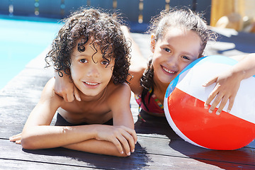 Image showing Pool, smile and portrait of children with ball for swimming lesson, activity or hobby fun. Happy, summer and kids with equipment for skill, playing or tricks in water of outdoor backyard at home.