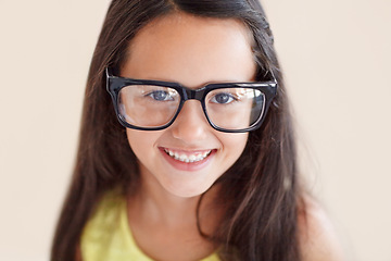 Image showing Smile, glasses and portrait of girl child with optical care, health and wellness in a studio. Happy, optometry and face of kid with spectacles for vision with positive, good and confident attitude.