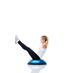 Image showing Woman, exercise and balance on bosu ball for core training, muscle and workout isolated on white background. Fitness equipment, strength and endurance with mockup space and strong athlete in studio