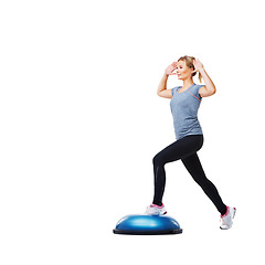 Image showing Woman, bosu ball and stepping for exercise, workout or fitness on a white studio background. Young active female person or athlete on half round object in pilates, health and wellness on mockup space