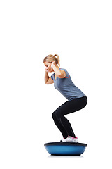 Image showing Woman, bosu ball and squat for fitness, exercise or workout on a white studio background. Young active female person or athlete on half round object for training, health and wellness on mockup space