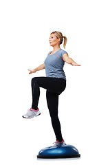 Image showing Woman, bosu ball and balance exercise for workout or body training on a white studio background. Active female person on half round object for pilates, practice or health and fitness on mockup space