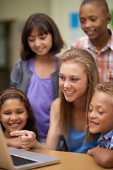 Image showing Children, tutor and computer in classroom for education, learning and e learning information or group project. Happy diversity kids, students and girl with leadership on laptop at school for support