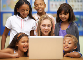 Image showing Children, students and computer in classroom for education, learning and video streaming with group project. Happy diversity kids and girl with leadership on laptop at school for online information