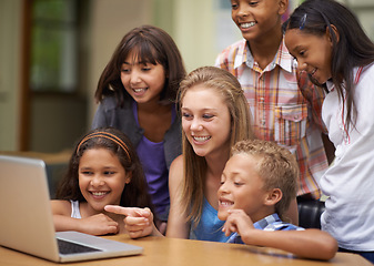 Image showing Children, students and laptop in classroom for education, learning and video streaming with group project. Happy young kids and girl with leadership on computer at school for online information