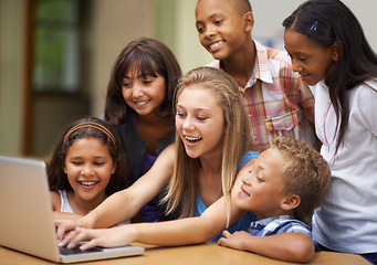 Image showing Children, typing on computer and learning in classroom for education, teaching and website information or group project. Happy diversity kids, students and girl with leadership on laptop at school