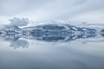 Image showing Serene Winter Landscape of Snow-Capped Mountain Reflected in Cal