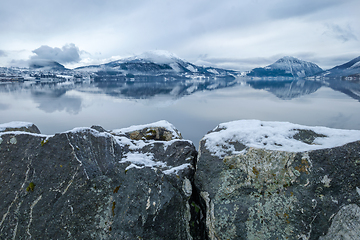 Image showing Tranquil Winter Morning by the Snow-Covered Lake With Mountain R