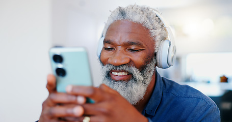 Image showing Senior black man, headphones and phone in music or audio streaming, communication or networking at home. Face of mature and happy African male person with smile listening on mobile smartphone headset