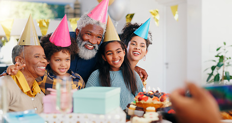 Image showing Cake, happy and family at birthday party celebration together at modern house with candles. Smile, excited and young children with African father and grandparents with hats for photograph at home.