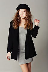 Image showing Happy, portrait and woman with vintage fashion, style and aesthetic in grey background of studio. Confident, smile and girl with pride in unique or retro clothing with model in hat for trendy outfit