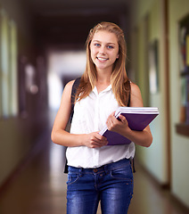 Image showing Happy woman, portrait and student with books at school hallway for education, study or learning. Young female person or teenager smile with textbooks or backpack for studying or knowledge in corridor