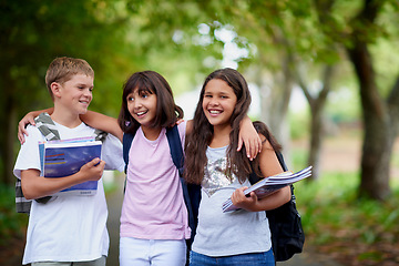 Image showing Happy kids, friends and hug with backpack in park for unity, teamwork or walking to school together. Group of young people smile in nature with bag or books for learning, education or outdoor forest