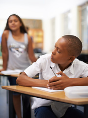 Image showing University, copy or students cheating in exam with paper, school corruption or education fraud. Cover, girl peeking or smart male child learner hiding or writing answers in test in classroom at desk