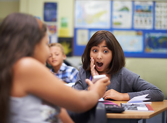 Image showing High school, surprise or girl with a phone for a secret, gossip or rude message online in classroom. Show news, share or shocked children with picture on mobile app or social media for cyber bullying