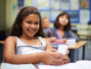 Image showing School, students or portrait of girl with phone for texting, gossip or message notification in classroom. News, sharing or happy child with a meme on mobile app or social media for online distraction