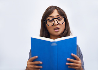 Image showing Child, book and reading for development in education, information and knowledge by white background. Girl, student and learning or studying in studio, academy and notebook for story and growth