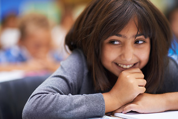 Image showing Girl, education and happy in classroom for knowledge, information and notes for learning in school. Female person, book and confidence for assessment or test, studying lesson and smiling at academy