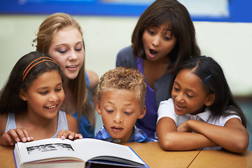 Image showing School teacher, classroom and reading book with students, education and knowledge or learning. Female person, children and literature for english development, collaboration and unity at academy