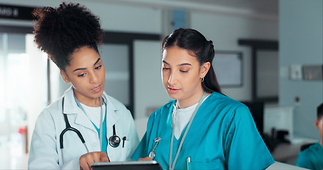 Image showing Team of doctors, discussion and women on tablet in hospital for research, report advice and telehealth. Healthcare, clinic and people talking on digital tech for medical service, results and meeting