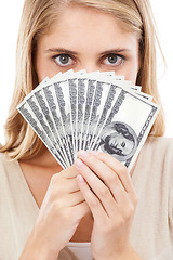 Image showing Face, woman and money fan for finance, prize or reward with achievement or success on white background. Winner with cash in hands, eyes and dollar bills for financial freedom with bonus in studio