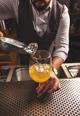 Image showing Bartender is making cocktail