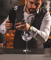 Image showing Bartender preparing cocktail