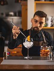 Image showing Barman is decorating cocktail